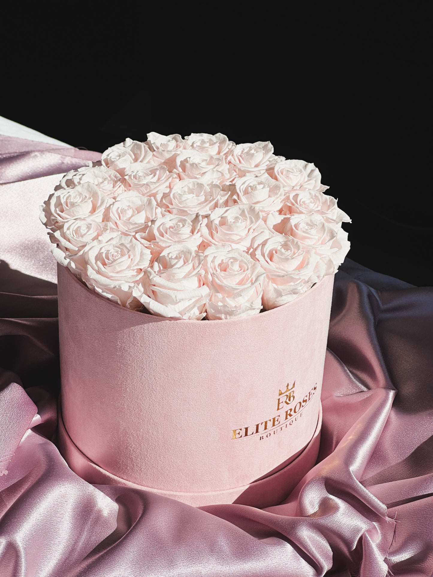 Baby pink roses in a medium round box